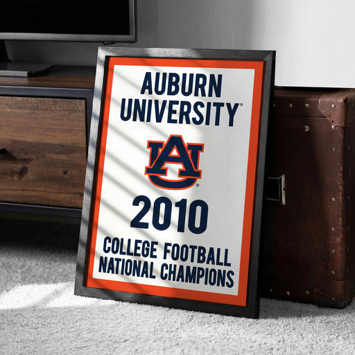 A framed sign celebrating Auburn University's 2010 College Football National Champions, with the Auburn University logo prominently displayed.