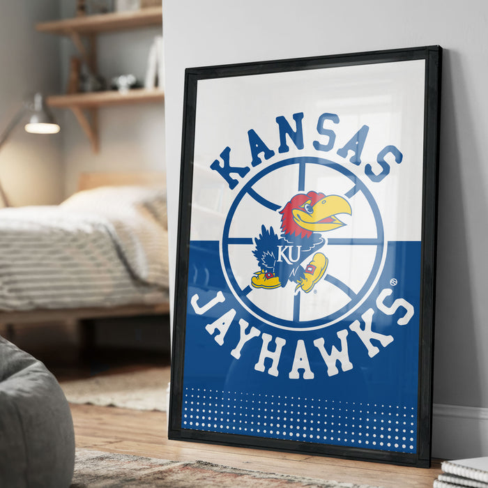A framed poster of the Kansas Jayhawks, a sports team, is displayed on a wall in a bedroom.