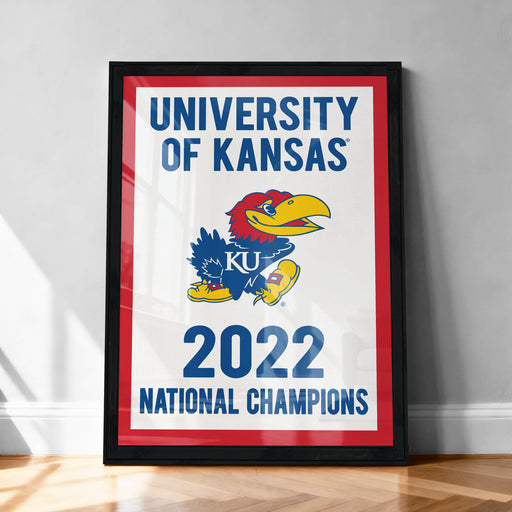 A framed poster celebrating the University of Kansas' national championship victory in the year 2023.