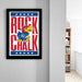 a framed poster of a bird character with the text "ROCK CHALK" on it, hanging on a wall.