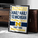 a framed poster with text and a logo, placed on a carpeted floor next to a wooden chest.