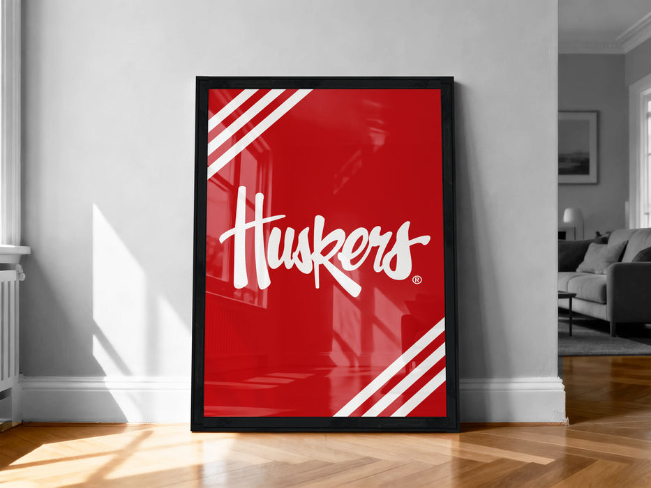 A large red poster with the word "Huskies" written on it, displayed on a wall in a room with a wooden floor.