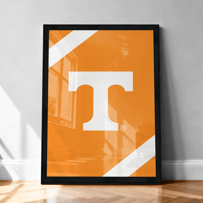a large framed poster with a bold, white letter "T" on an orange background.