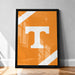 a large framed poster with a bold, white letter "T" on an orange background.