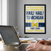 a framed poster with text on it, hanging on a wall above a desk with a laptop and other items on it.