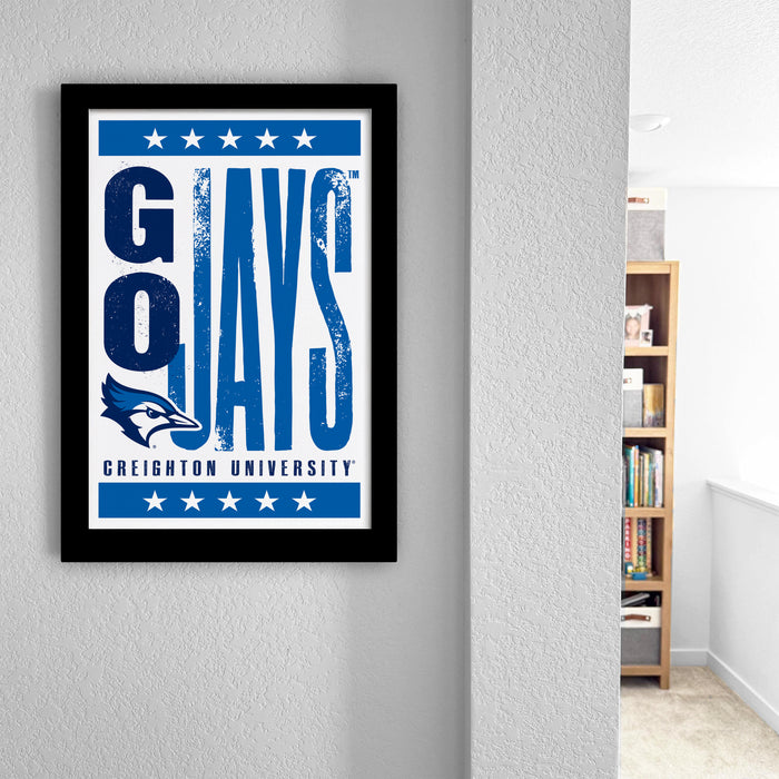 a framed poster with the text "GO JAYS GREIGHTON UNIVERSITY" on it, hanging on a wall.