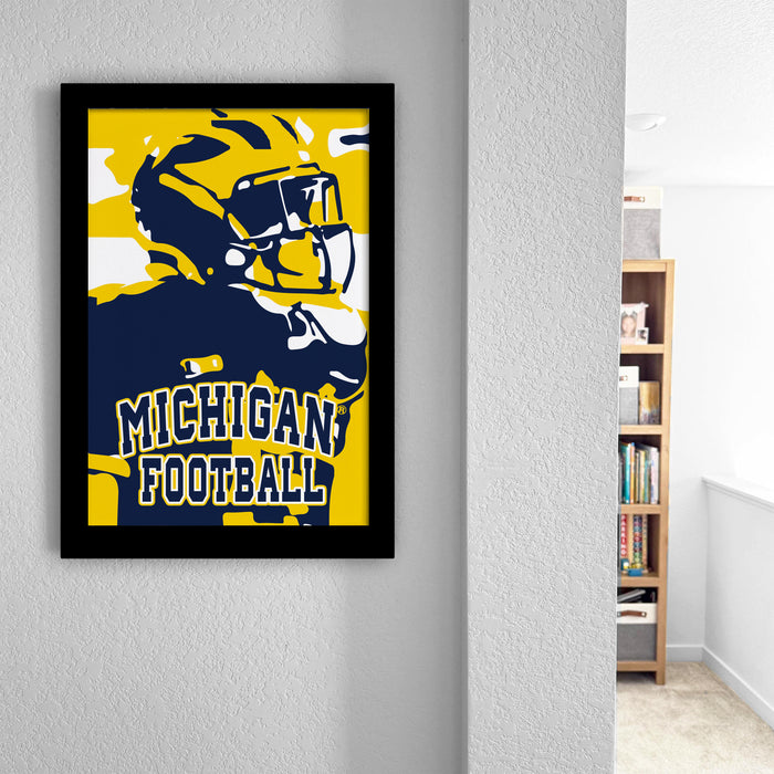 A framed poster of a football player in a yellow and blue uniform, with the text "MICHIGAN FOOTBALL" displayed prominently.