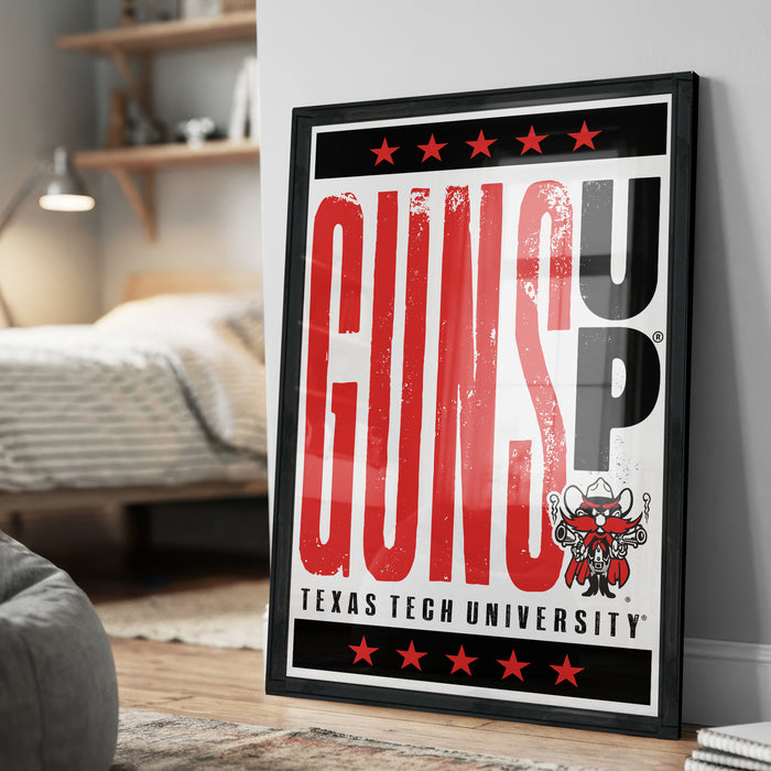A framed poster with the text "GUNS UP" and a graphic of a gun, displayed on a wall in a room.