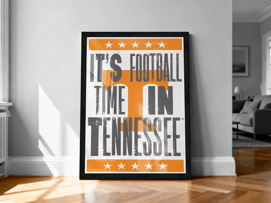 A framed poster with the text "IT'S FOOTBALL TIME IN TENNESSEE" displayed prominently on it, along with a border of stars.