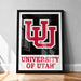 A framed poster of the University of Utah logo is displayed on a wooden floor against a white wall.