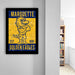 a framed poster of a cartoon character, likely representing the Marquette University Golden Eagles, displayed on a wall.