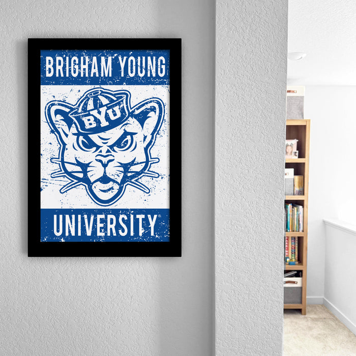 a framed poster of a university mascot, which is mounted on a wall.