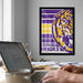 a framed poster of a tiger's head with the text "BAYOU BENGALS" on it, hanging on a wall above a desk with a laptop and other items on it.