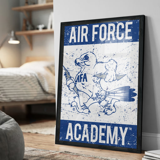 a framed poster with the text "AIR FORCE ACADEMY" and an illustration of a bird, likely representing the Air Force Academy.