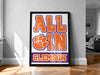 A framed poster with the text "ALL IN" and a paw print logo, which appears to be related to the University of Southern Alabama (USA) football team.