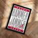 a framed poster with the text "RAMMER JAMMER" and "ALABAMA CRIMSON TIDE" printed on it, placed on a wooden floor.