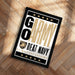 A framed poster with the text "GO ARMY BEAT NAVY" and a military insignia, placed on a wooden floor.