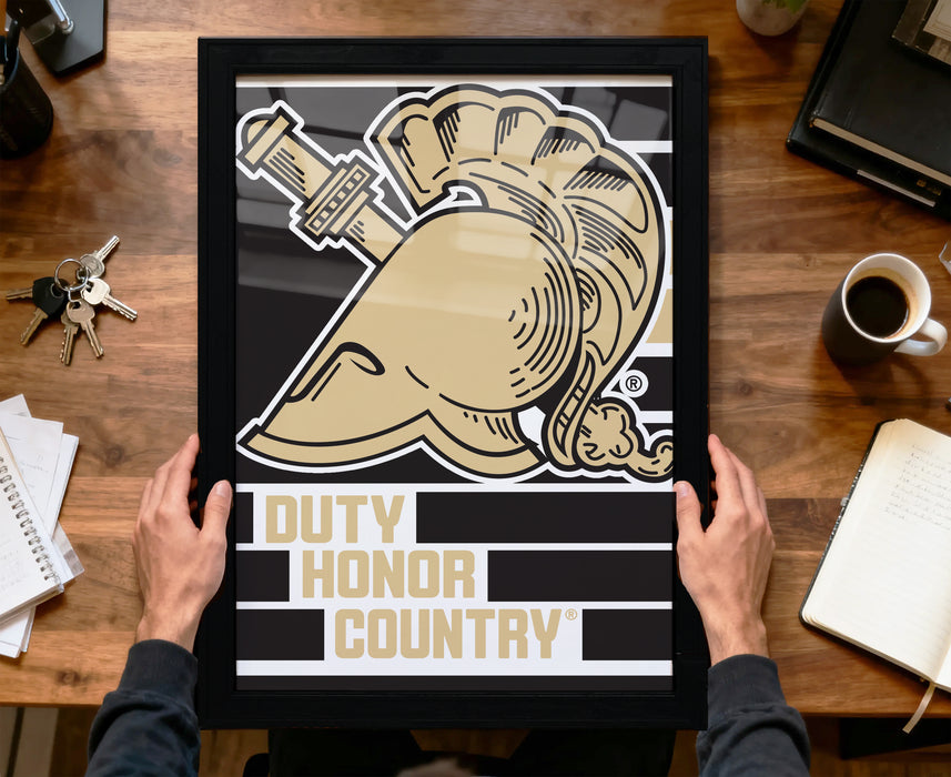 A person is holding up a framed poster with a graphic design featuring a helmet and the text "DUTY HONOR COUNTRY".