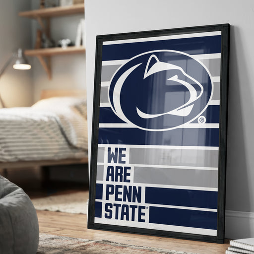 A framed poster with the Penn State logo and the text "WE ARE PENN STATE" displayed on a wall.