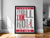 A framed poster with the text "ROLL TIDE A" in large letters, surrounded by red stars, is displayed on a wall in a room.