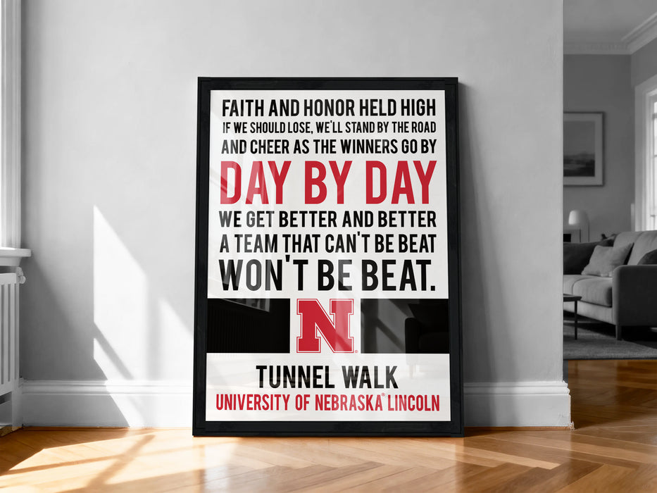 a framed poster with motivational text, including a quote about Nebraska football and the University of Nebraska Lincoln.