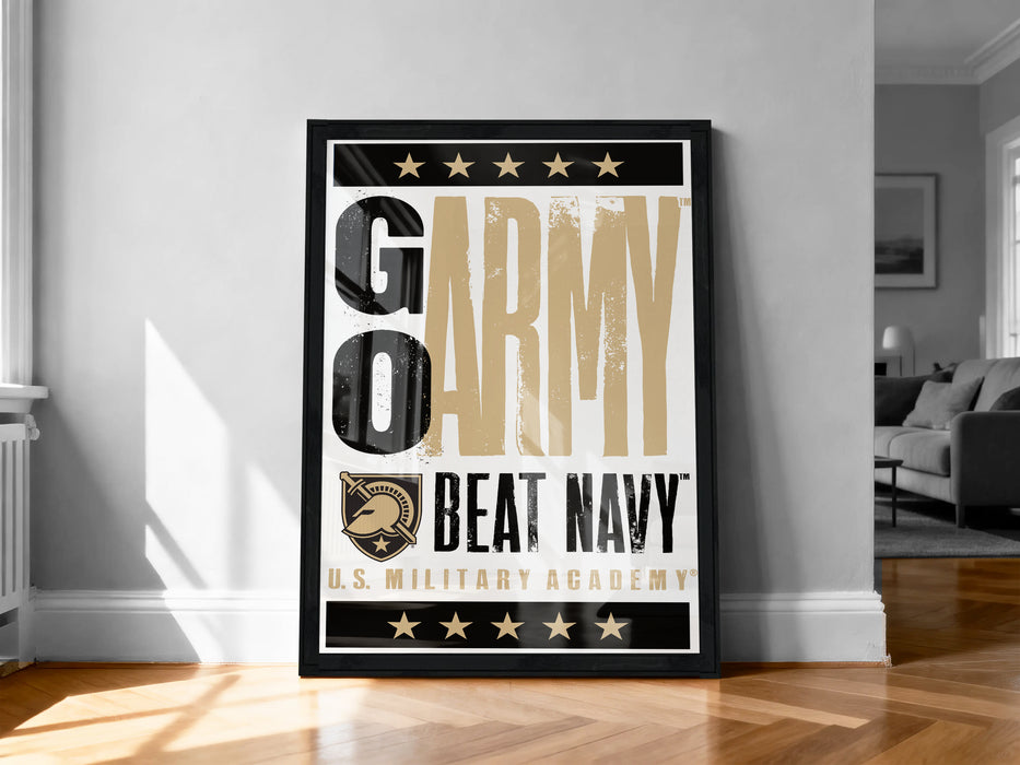 A framed poster with the text "GO ARMY BEAT NAVY" and a logo, placed on a wooden floor against a white wall.