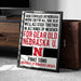 a framed poster with text that reads "There is no place like Nebraska where they're all true blue we'll all stick together in all kinds of weather for dear old Nebraska U. FIGHT SONG UNIVERSITY OF NEBRASKA LINCOLN".