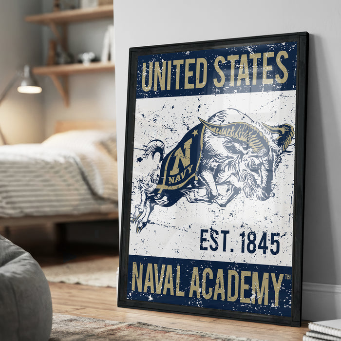 A framed poster with the text "UNITED STATES NAVAL ACADEMY EST. 1845" and an illustration of a bull, representing the naval academy.