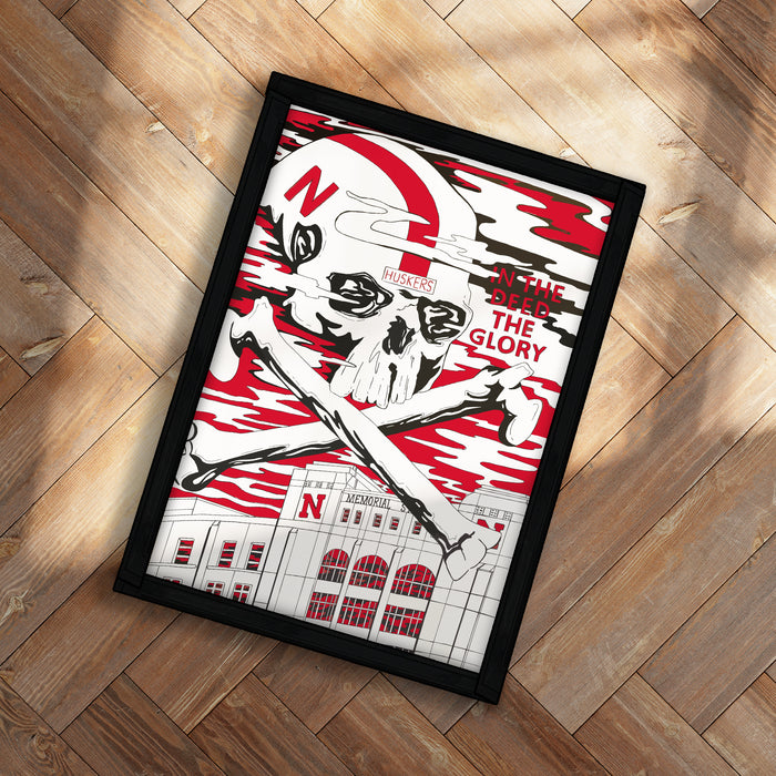 A framed poster featuring a skull and crossbones design with the text "In the SPECTRE THE GLORY" and "NUKE'S" on it, placed on a wooden floor.