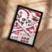 A framed poster featuring a skull and crossbones design with the text "In the SPECTRE THE GLORY" and "NUKE'S" on it, placed on a wooden floor.