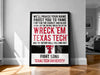 The image is a framed poster with text that reads "WE'LL PROUSE YOUR NAME BOOST YOU TO FAME FIGHT FOR THE SCARLET AND BLACK YOU WILL HIT EM, YOU WILL WRECK 'EM, HIT 'EM AND THE VICTORY BELLS WILL RING OUT" along with a logo for "TEXAS TECH".