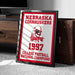 A framed sign displaying the Nebraska Cornhuskers' 1997 College Football National Champions.