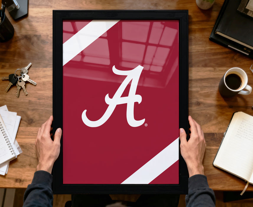 A person is holding a framed picture with the letter "A" on it, which appears to be a sports team logo.