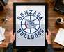 A person is holding up a framed poster with the Gonzaga Bulldogs logo on it, which features a bulldog in a basketball hoop design.