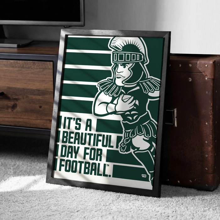 A framed poster featuring a cartoon character in a football uniform, with the text "It's a beautiful day for football."