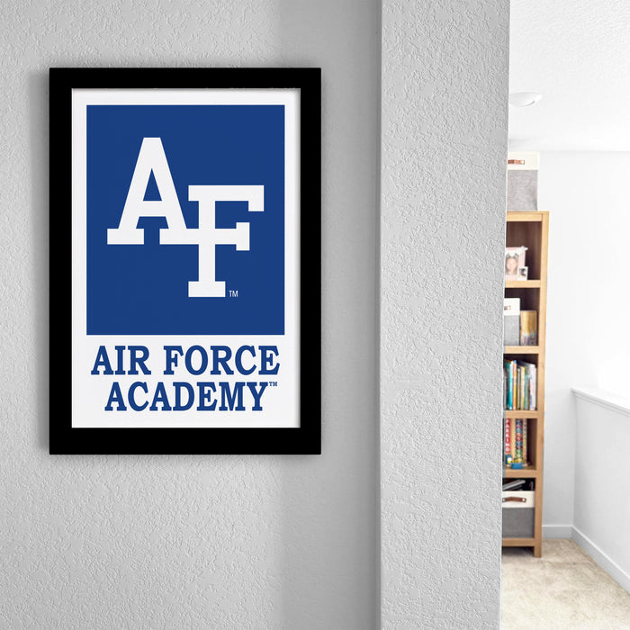 a framed sign for the Air Force Academy, with a bookshelf visible in the background.