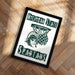 A framed poster with the text "Michigan State" and "Spartans" on it, featuring a graphic of a basketball player.