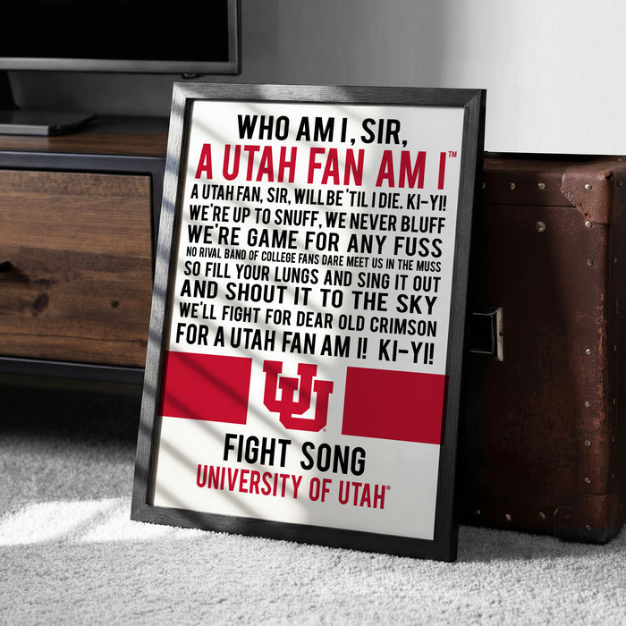a framed poster with text and a logo, placed on a carpeted floor next to a wooden chest.