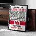 a framed poster with text and a logo, placed on a carpeted floor next to a wooden chest.
