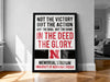 a framed poster with a quote from the University of Nebraska Lincoln, which reads "NOT THE VICTORY BUT THE ACTION NOT THE GOAL BUT THE GAME IN THE DEED THE GLORY."