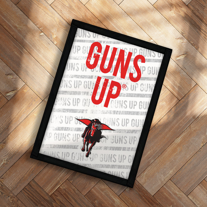 A framed poster with the text "GUNS UP" prominently displayed in the center, along with a graphic of a red bird or mascot.