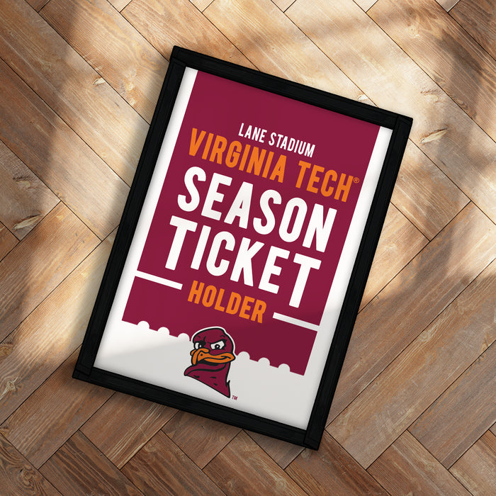 A framed poster advertising Virginia Tech's season ticket holder, featuring the university's logo and text.