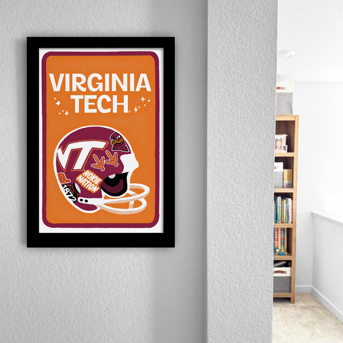 a framed poster of a Virginia Tech football helmet hanging on a wall.