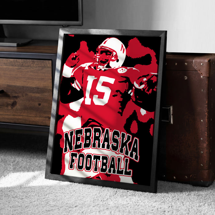 A framed poster of a football player wearing a Nebraska jersey, with the text "NEBRASKA FOOTBALL" prominently displayed.