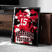 A framed poster of a football player wearing a Nebraska jersey, with the text "NEBRASKA FOOTBALL" prominently displayed.