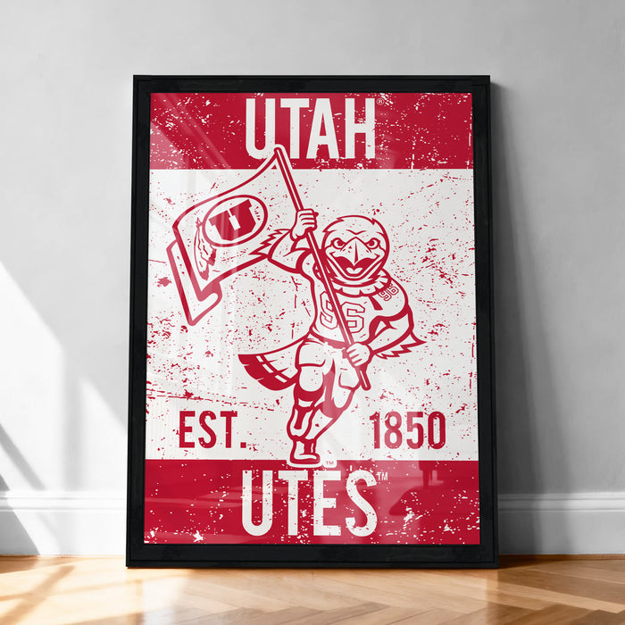 A framed poster featuring the logo and text of the University of Utah, with a red and white color scheme.