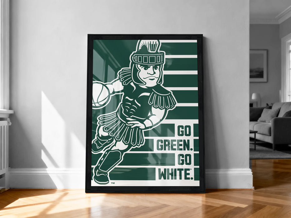 A framed poster featuring a cartoon character in a green outfit, holding a basketball, with the text "GO GREEN. GO WHITE." displayed below the image.