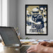 a framed poster of a football player on the wall, with a laptop and a coffee cup on a desk in the foreground.