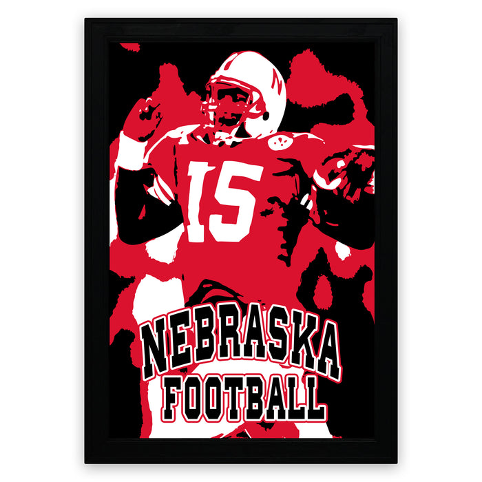 A framed poster featuring a football player in a red jersey with the number 15, representing the state of Nebraska.