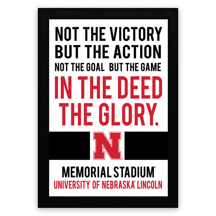 a framed quote that reads "NOT THE VICTORY BUT THE ACTION NOT THE GOAL BUT THE GAME IN THE DEED THE GLORY." The quote is from the Memorial Stadium University of Nebraska Lincoln.